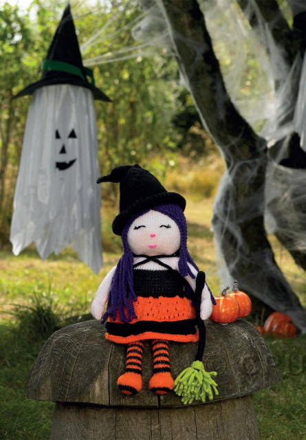 Knitted Halloween Witch with orange and black dress, purple hair and black hat, also a broom with green bristles 
